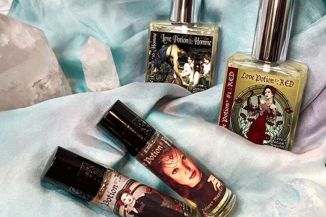 Perfumes from our signature collection on a marbled white and cyan scarf with quartz crystal towers and moons.