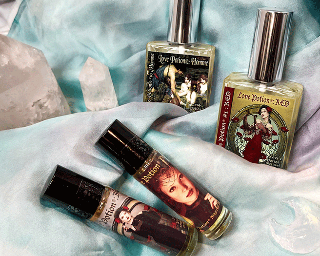Perfumes from our signature collection on a marbled white and cyan scarf with quartz crystal towers and moons.