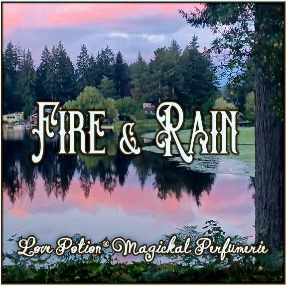 Our Fire & Rain perfume smells of summer rain and hard apple cider. The label shows a sunset view of a forested lake.