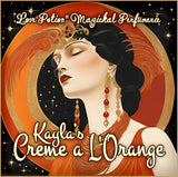 Kayla’s Creme A L’Orange custom perfume blends orange with creams and spices. Label shows a woman draped in orange.