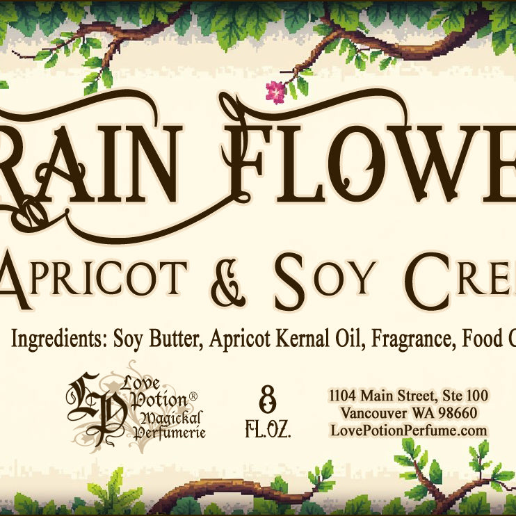 Label for apricot and soy creme. This body cream is scented like rainforest flowers and the label art features branches with leaves and pink flowers.