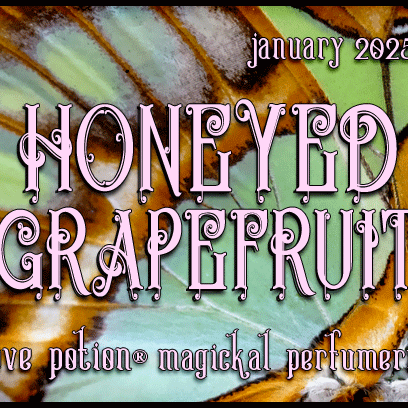 Honeyed Grapefruit layerable perfume by Love Potion. Label shows green and orange butterfly wings.
