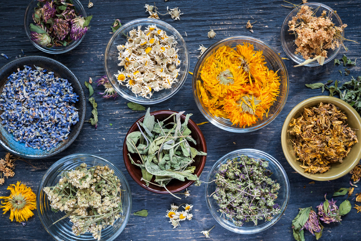 Bowls of various herbs and flowers used to make meaningful, clean perfume