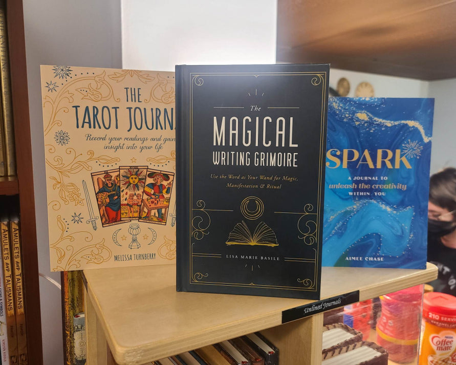 Some books you might find on our shelves: The Tarot Journal. The Magickal Writing Grimoire, and Spark.