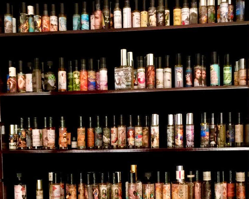 Shelves of handmade Love Potion clean perfumes and pheromone bottles in our Magickal Marketplace store.
