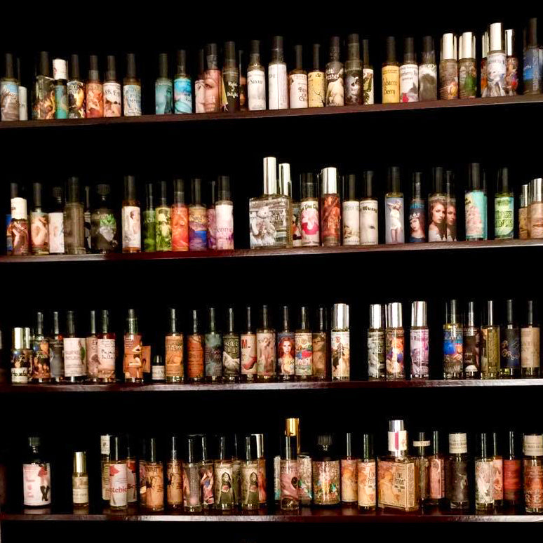 Shelves of handmade Love Potion clean perfumes and pheromone bottles in our Magickal Marketplace store.