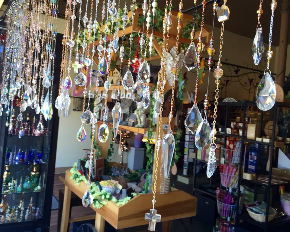 Crystal pendant sun catchers hanging by the window at our shop.