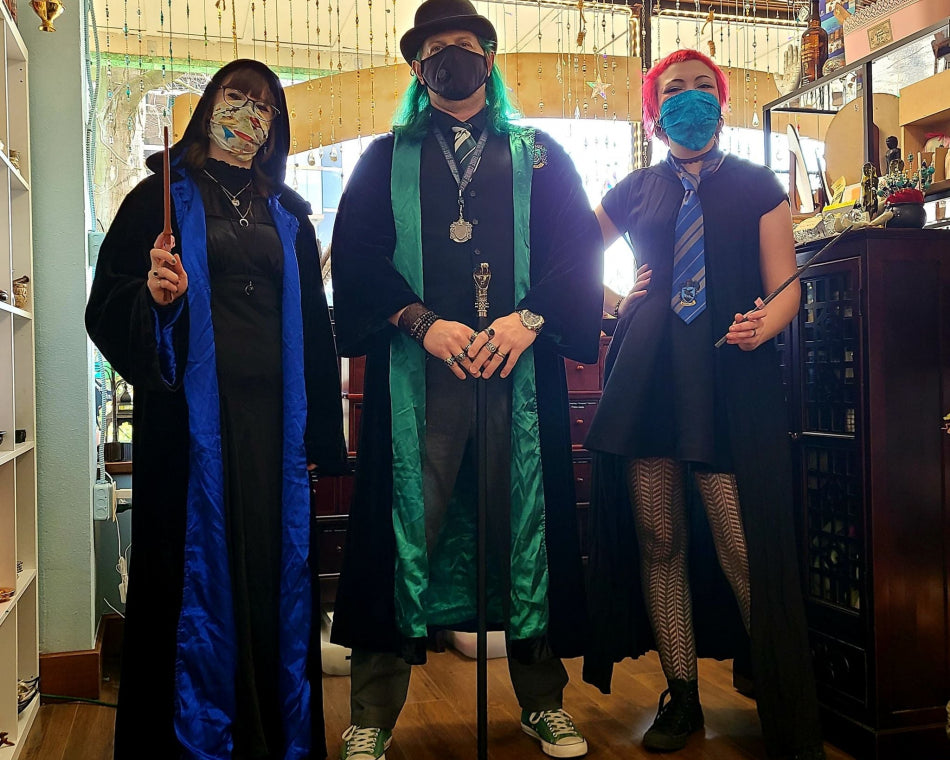Shop employees don Ravenclaw and Slytherin robes to wield a variety of wands and canes.