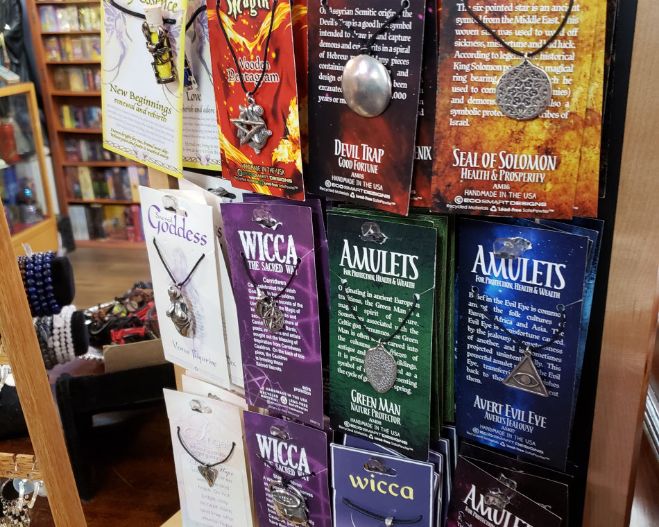 Various types of protective necklaces and amulets on display in the shop.