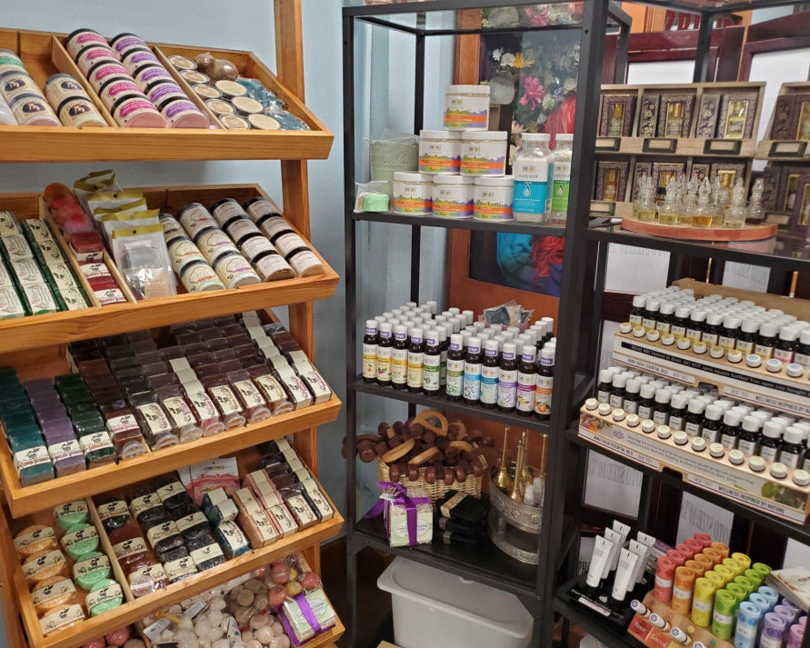 Luxurious scrubs, soaps, and bath bombs on shelves displayed at Love Potion Marketplace.