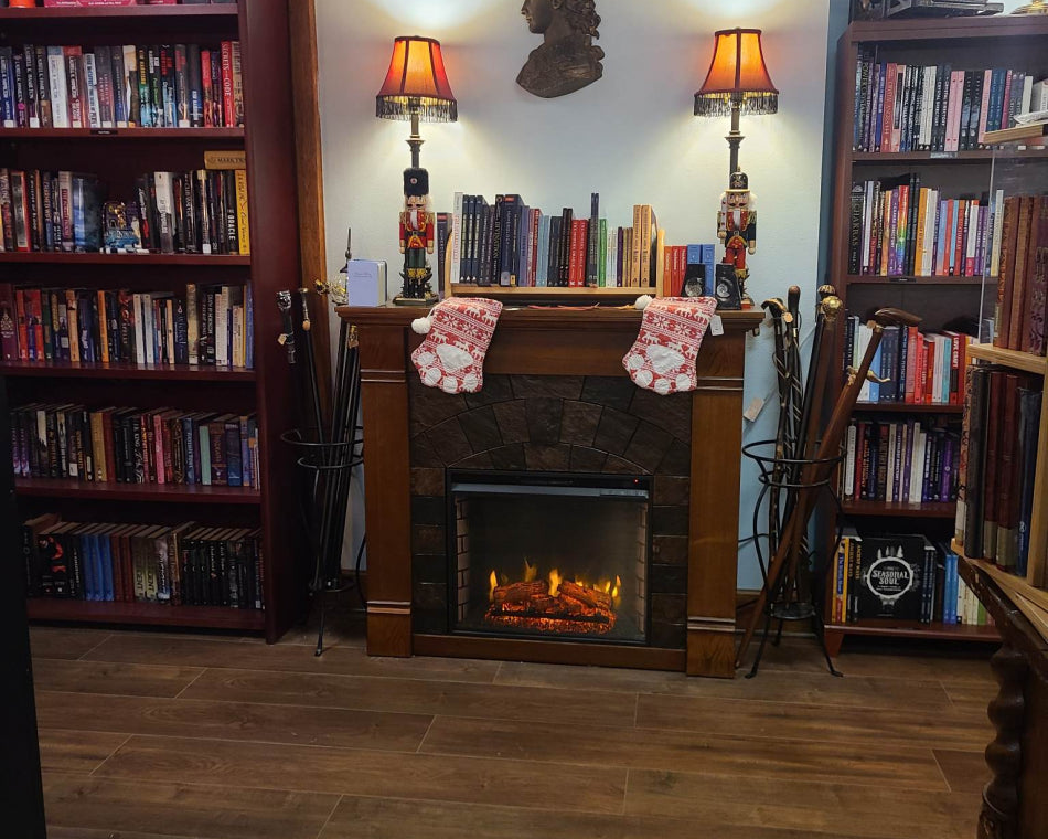 Our fireplace and floor-to-ceiling bookshelves create a cozy and enchanting atmosphere, amplified by cat paw stockings!