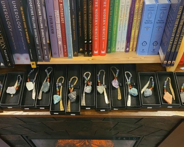 Bookmarks made of stone and metal on display above the fireplace.