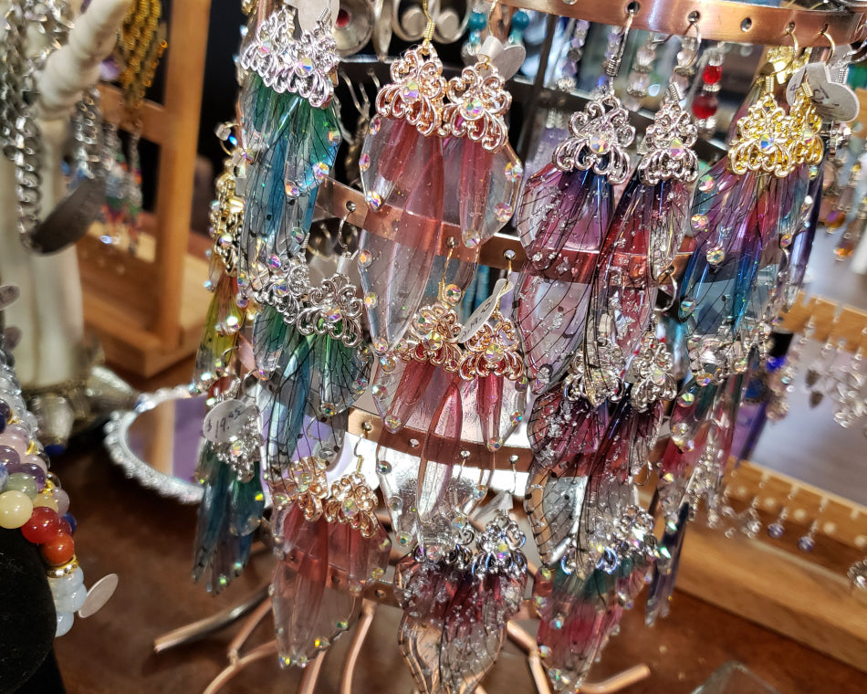 A wide range of butterfly wing resin earrings on a cute stand.
