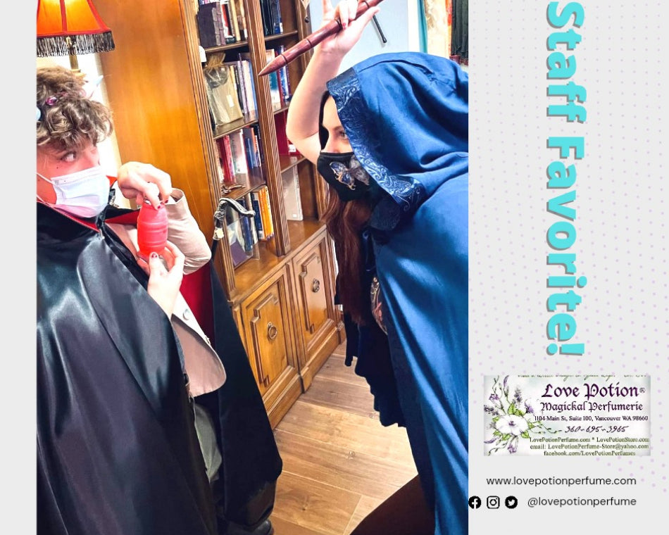 Jeanna in a blue robe brandishing a vampire stake directed at Claire, in a black and red cloak.