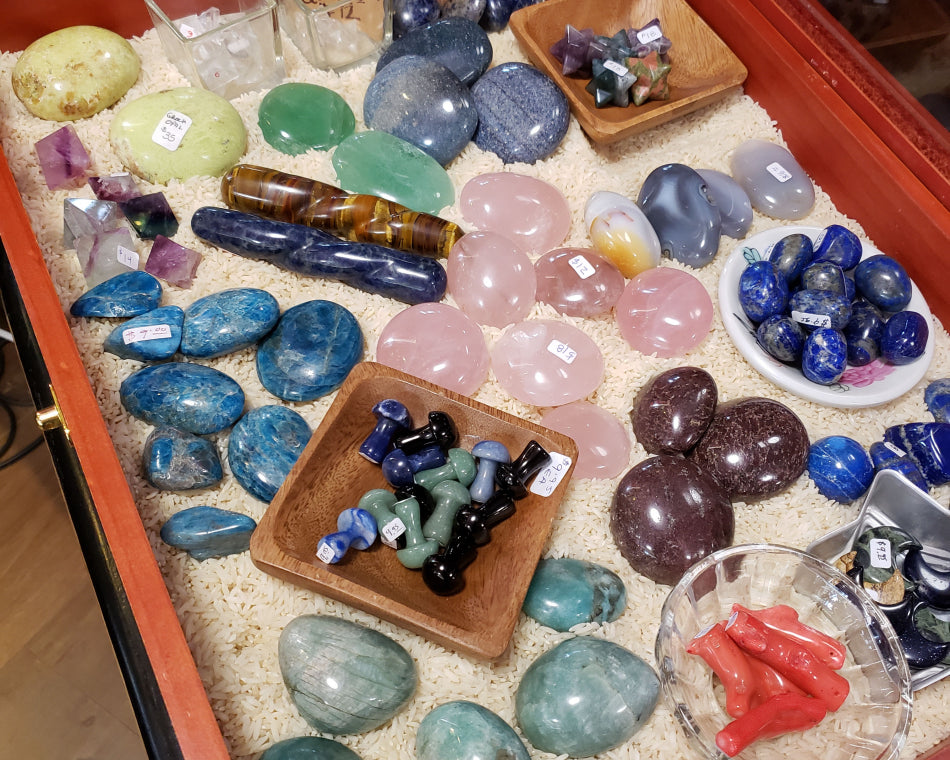 Variety of crystals including lapis lazuli, rose quartz, and coral.
