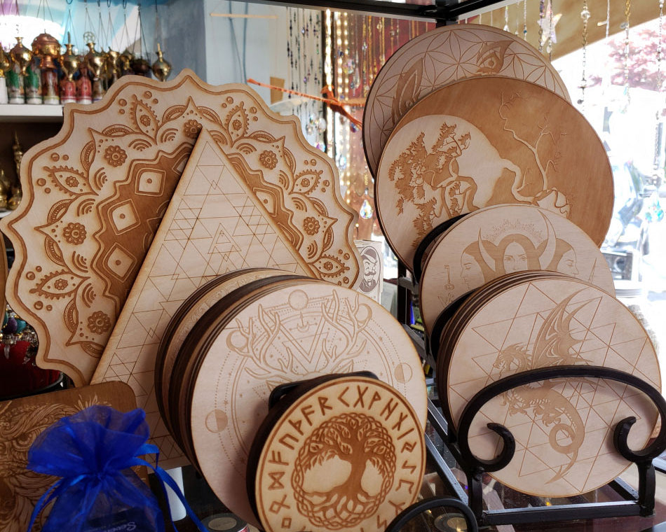 Crystal grids made of wood in different sizes with a variety of magical designs.