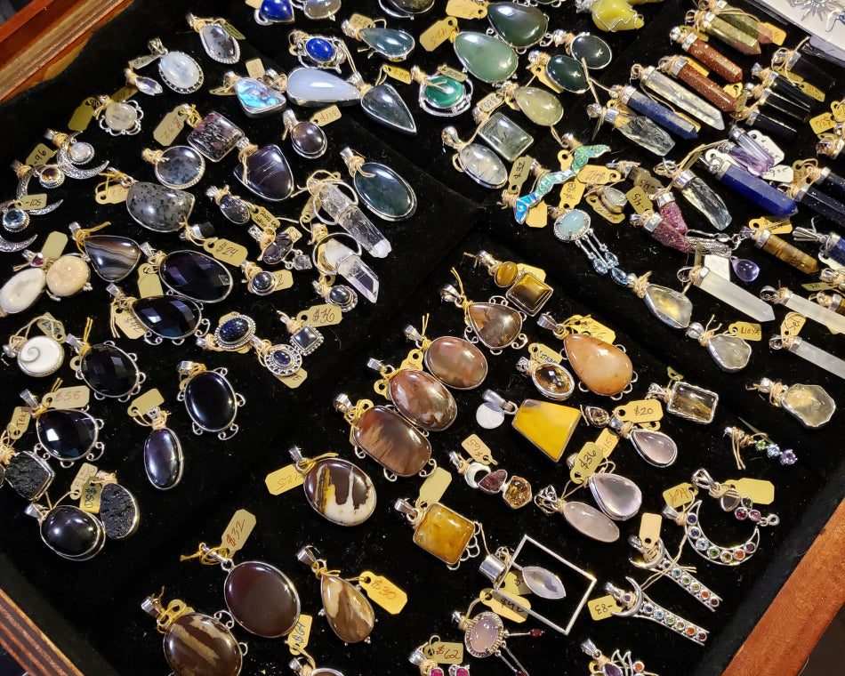 Our collection of crystal necklaces on display in the jewelry case.