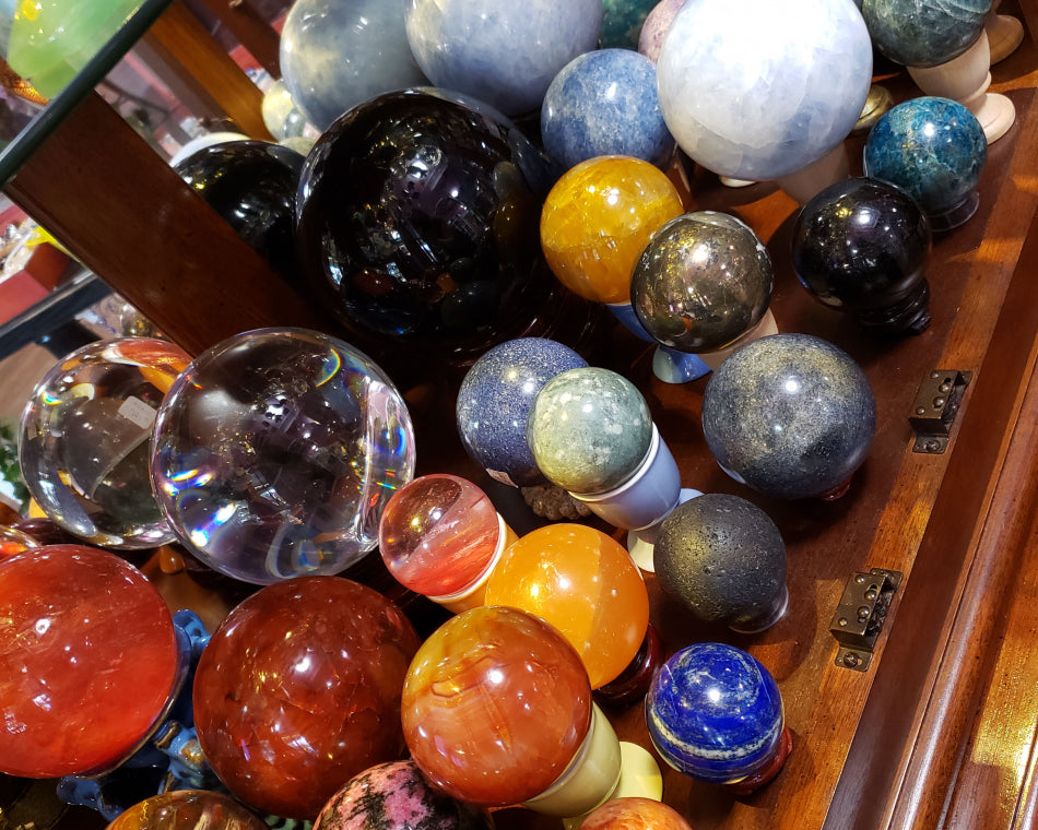 A collection of smooth crystal spheres made using different materials and in different sizes.