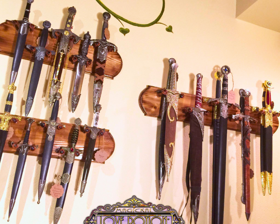 The image displays three distinct dagger wall mounts, each holding five daggers.