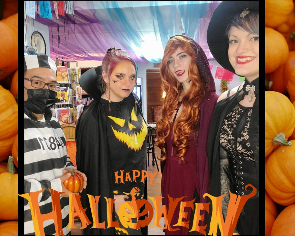 Our crew's amazing Halloween costumes, including an inmate, two vampires, and a witch.