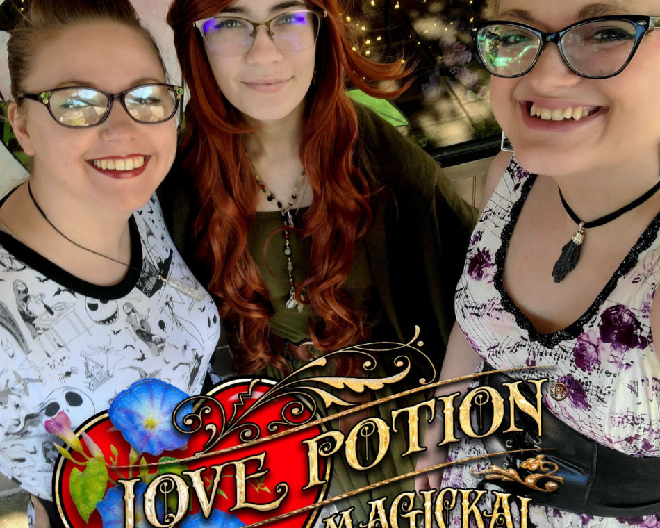 Jeanna, Val, and Kimi striking a pose in front of a mushroom painted on our storefront window.