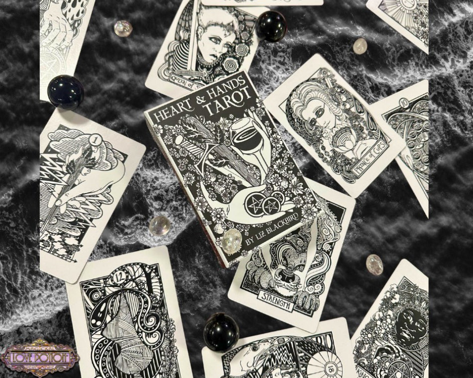 Heart & Hands Tarot deck by Liz Blackbird surrounded by sample cards and monochromatic gemstones.