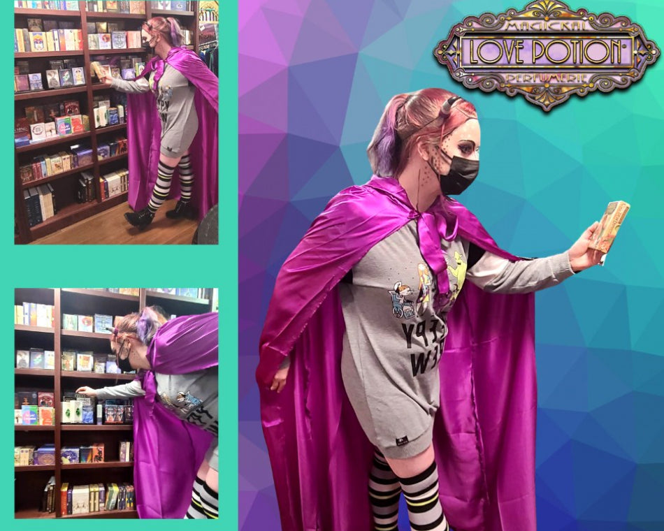Jeanna in a purple cloak, Nightmare Before Christmas dress, and striped socks looking at tarot decks.