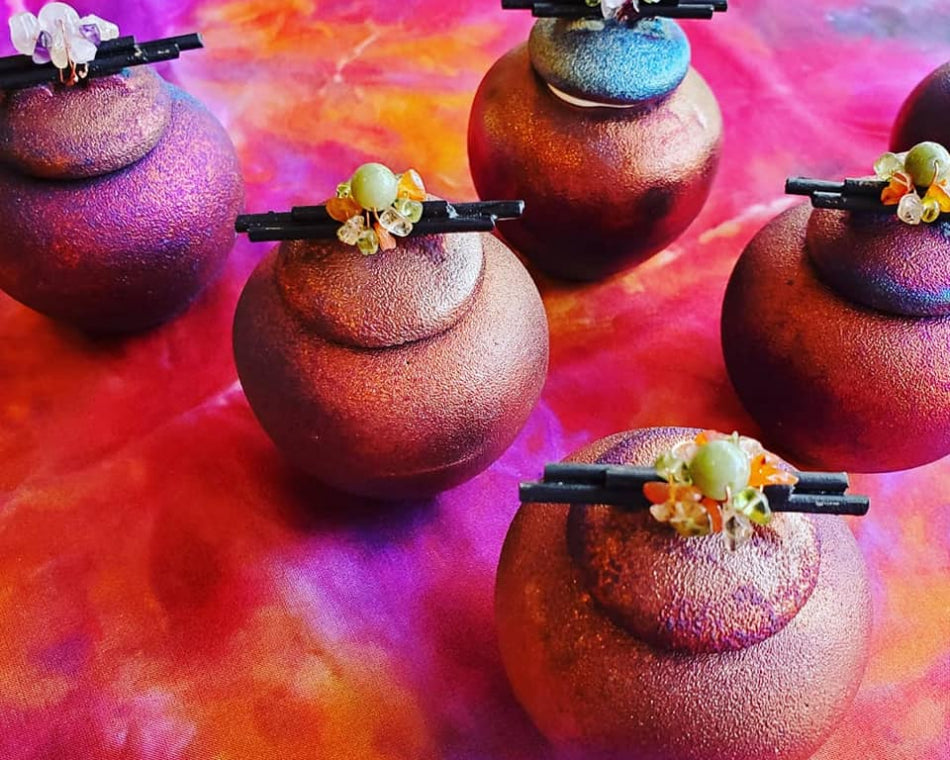 Unique raku ware pottery jars adorned with a rainbow of colors and beads.