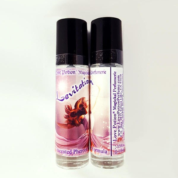 Love Potion Pheromone label for Levitation, featuring beautiful woman joyously dancing, on glass product bottles.