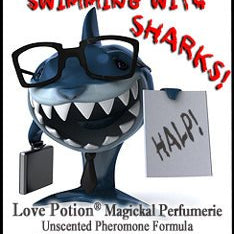 Love Potion: Swimming with Sharks pheromone label featuring a funny shark dressed for the office, wearing glasses and holding a briefcase and a sign that says, HELP!