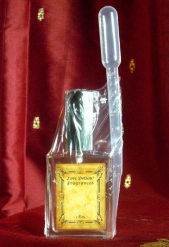 Glass spray bottle with silver cap and a perfume transfer pipette.