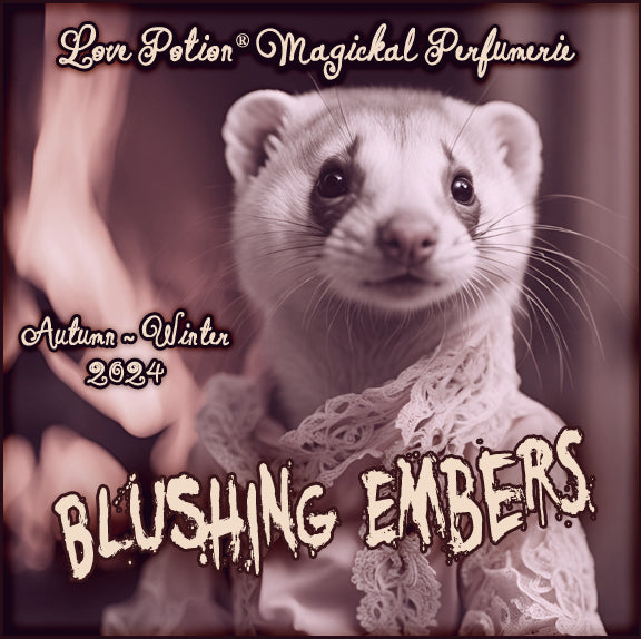 Blushing Embers clean perfume features smokey woods and sugared berries. Label shows a ferret lady in front of a fire.