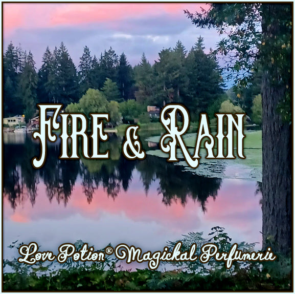 Our Fire & Rain perfume smells of summer rain and hard apple cider. The label shows a sunset view of a forested lake.