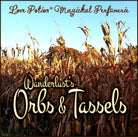 Wanderlust’s Orbs & Tassels autumn apple cider and harvest breeze clean perfume. Label features swaying cornstalks.