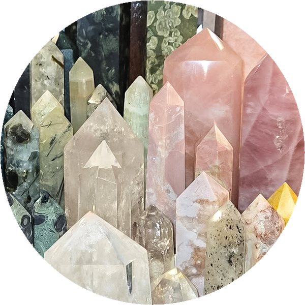 Thumbnail for the crystal section of our store gallery. Shows pointed towers of rose quartz, clear quartz, and other crystals.