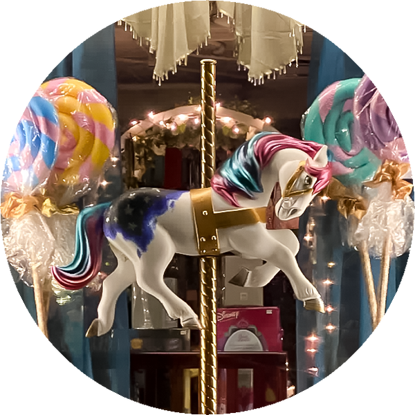 Thumbnail for the toy section of our store gallery. Shows the merry-go-round and giant lollipop window display for the kids' area.