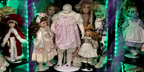 Collection of haunted vintage dolls for sale with different outfits and styles displayed against a spooky background.