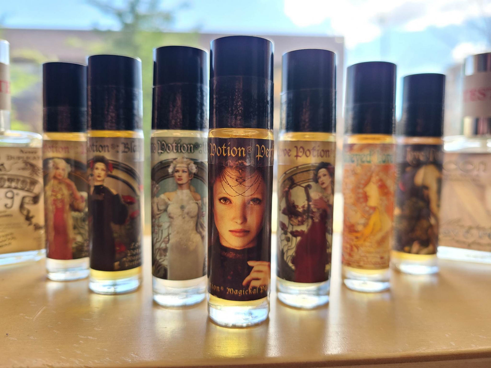 Handful of our signature fragrances in roll-on bottles placed in front of a shop window