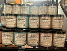Jars of handmade sugar and butter scrubs stacked in the Love Potion Magickal Marketplace