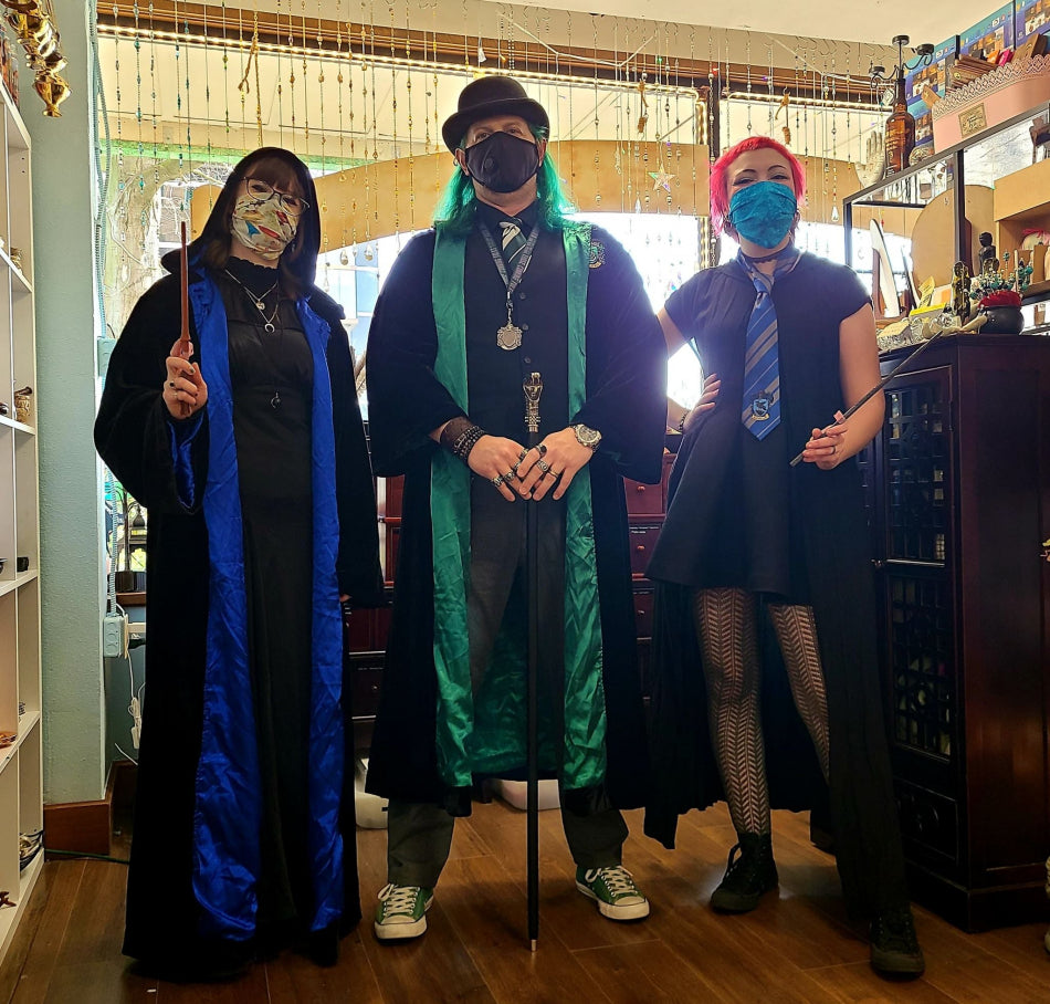 Shop employees don Ravenclaw and Slytherin robes to wield a variety of wands and canes.