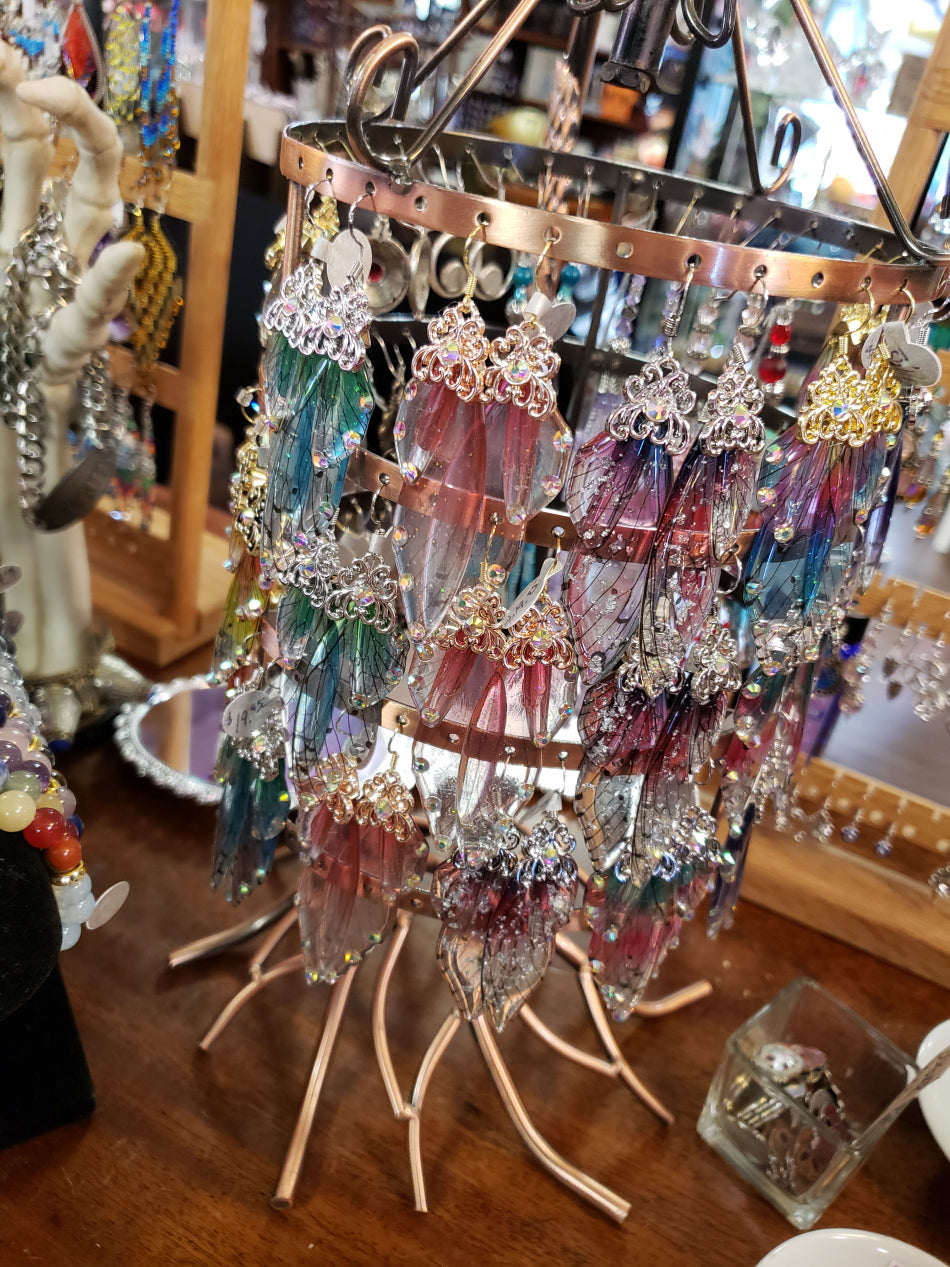 A wide range of butterfly wing resin earrings on a cute stand.