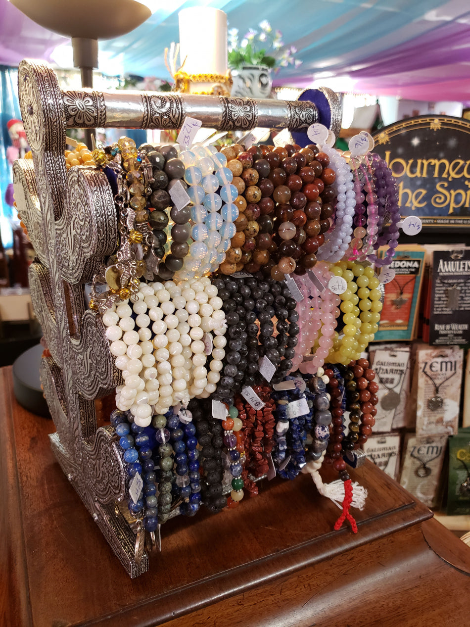 Selection of crystal bracelets on an elegant jewelry stand.