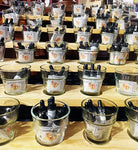 Photo showing a wood and glass display of pheromone product bottles. 